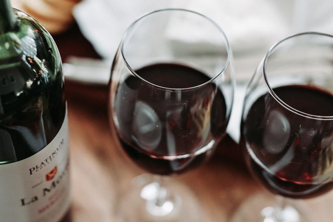 Bottle of red wine with two glasses