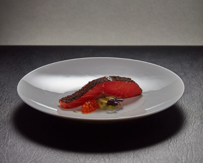 salmon coated in roe arranged beautifully on a plate