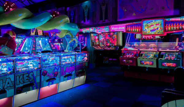 the inside of an arcade with neon lights everywhere