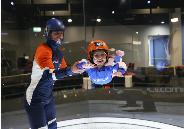 girl being taught to skydive by instructor