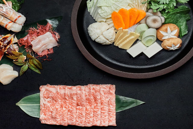 a table spread with a selection of Japanese food