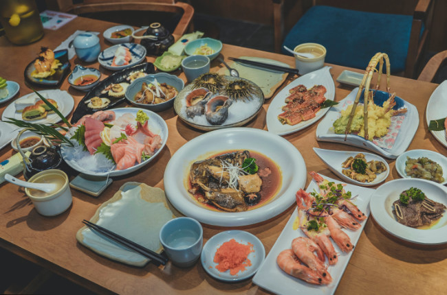 a selection of Japanese dishes laid out on a restaurant table
