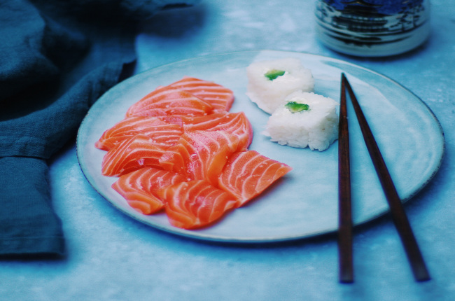 sliced salmon sashimi with a side of rice