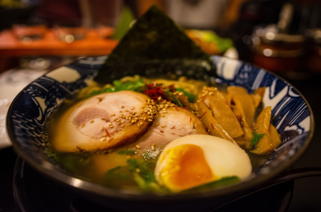 a bowl of ramen with sliced pork and egg