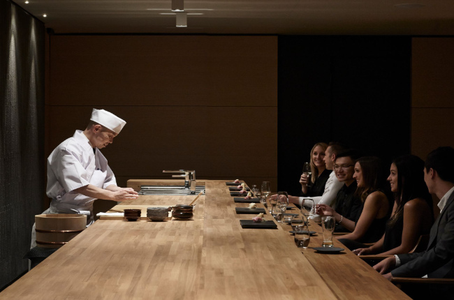 A Japanese chef preparing food for customers