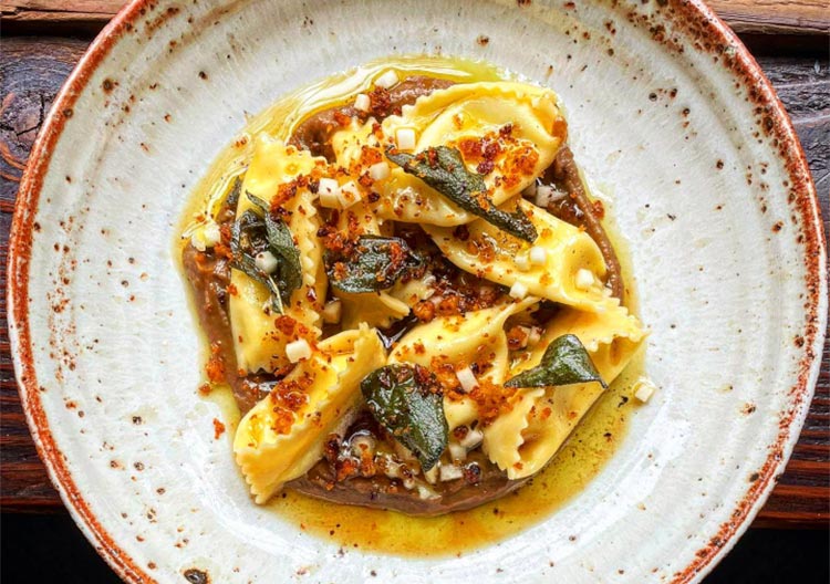 a close up of a bowl of pasta sitting in a bowl
