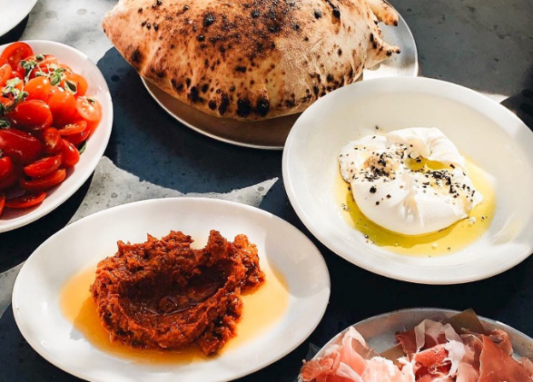 an assortment of italian food sitting on the table