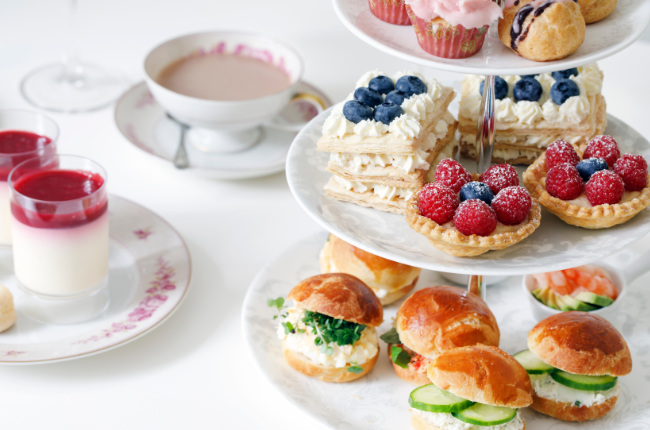 a selection of tarts, creams and sandwiches 