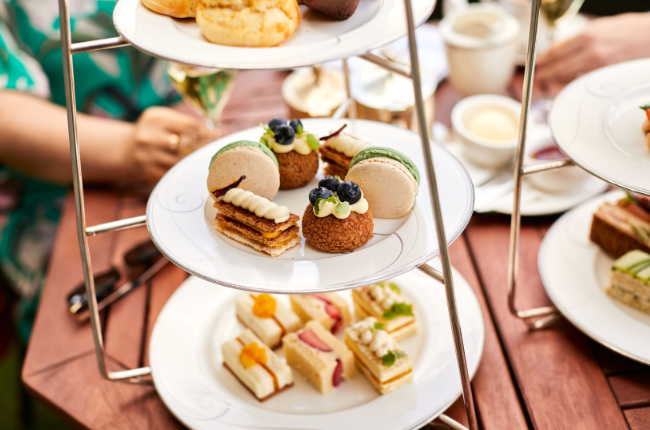 a selection of sandwiches and sweets on a table