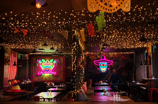 a Mexican restaurant lit up with glowing neon lights