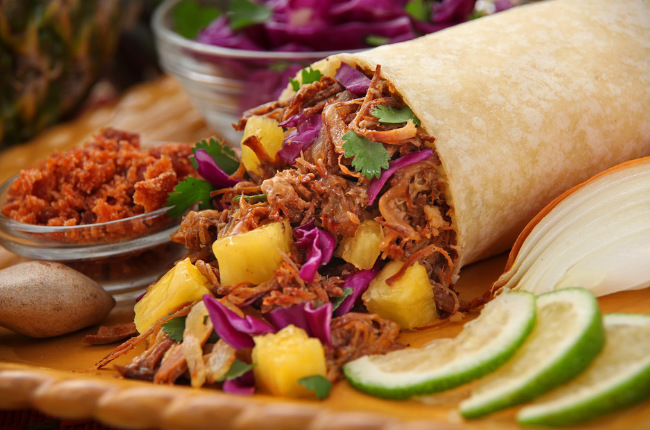 a delicious chicken burrito with pineapple
