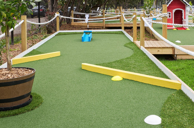 a fun mini golf course with lush green grass