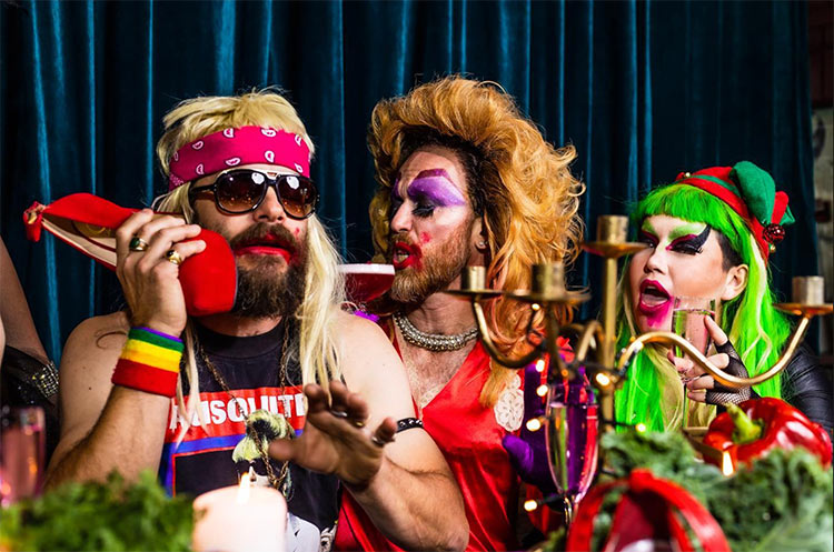 three drag queens wearing colourful outfits and make up