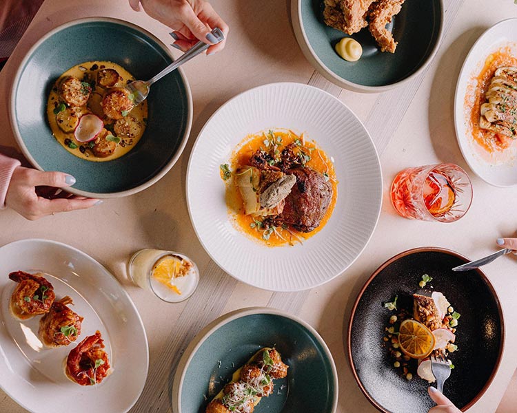 a restaurant table filled with items of the menu at mr joe dining