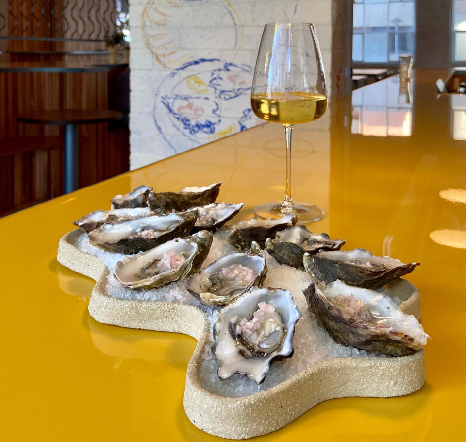 glass of wine and oysters at Hope st Radio