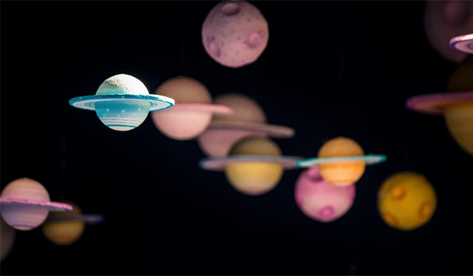 a blacked out background with planets on top