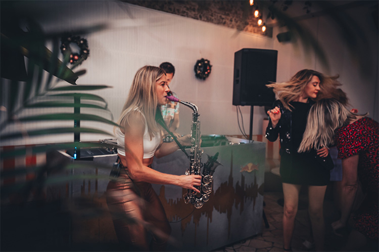 a woman playing the saxophone in a nightclub in sydney