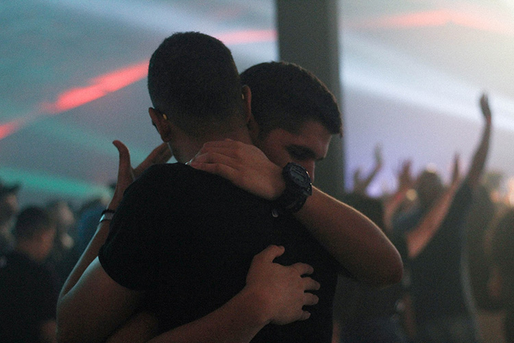 two men hugging at a nightclub in sydney