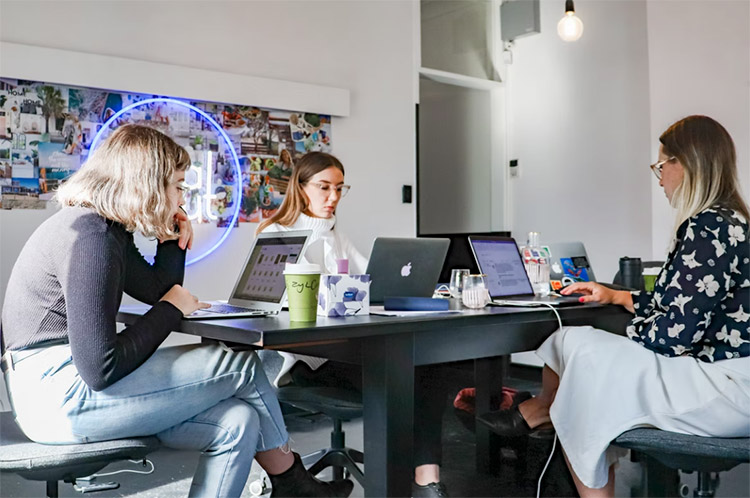 three women working in a co working space
