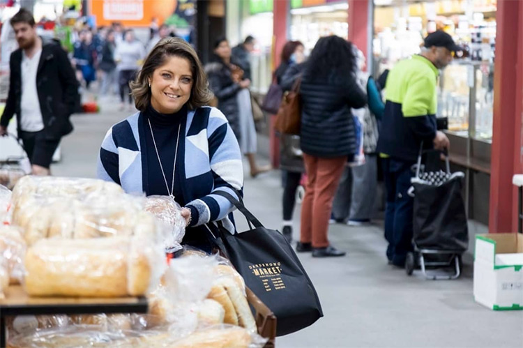 a woman standing enjoying the dandenong markets