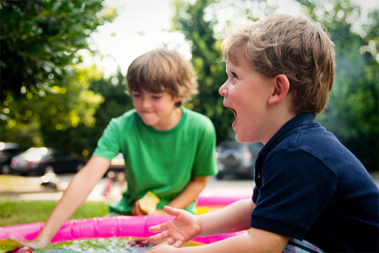 two kids playing at the park together