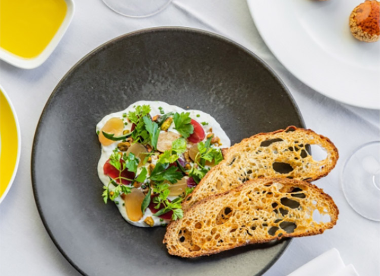 Stracciatella with roast pickled grapes, balsamic, pistachio, tarragon and crostini