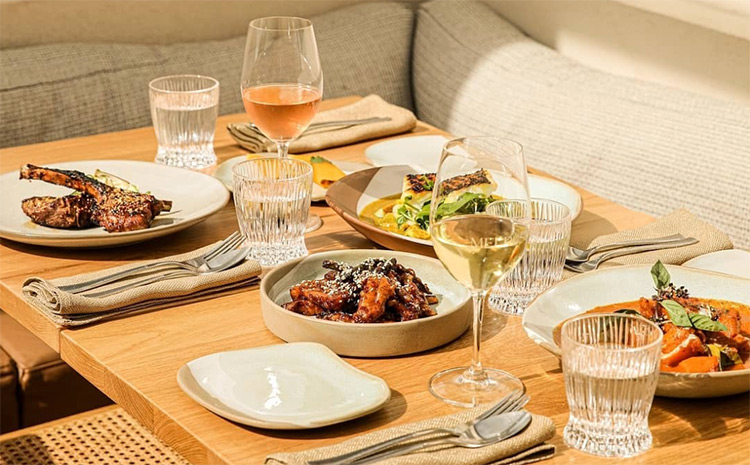 a table filled with food and cocktails