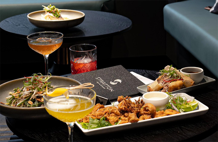 three types of dishes on a table with cocktails