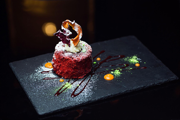 Fancy dessert on black plate